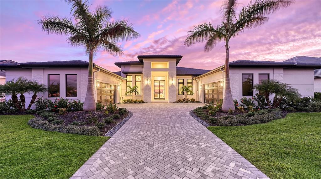 a front view of a house with a garden and patio