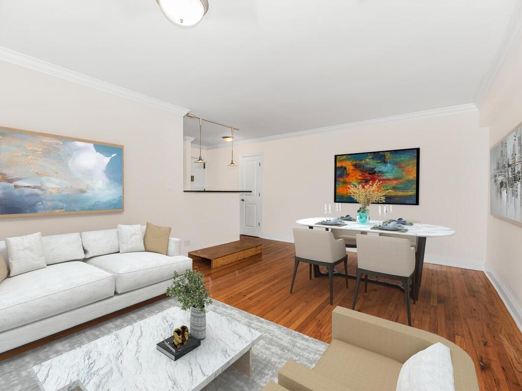 Living room featuring hardwood / wood-style flooring and ornamental molding