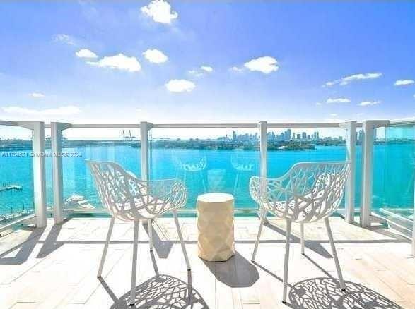 a view of a chairs and table in patio with a garden