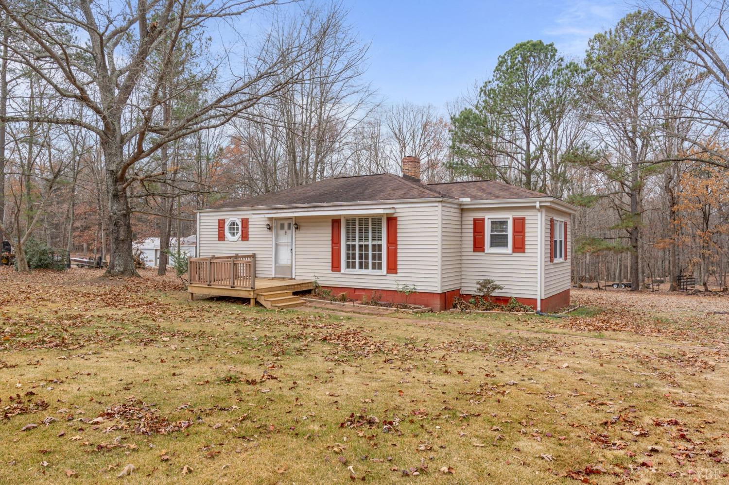 a view of a house with a yard covered in snow