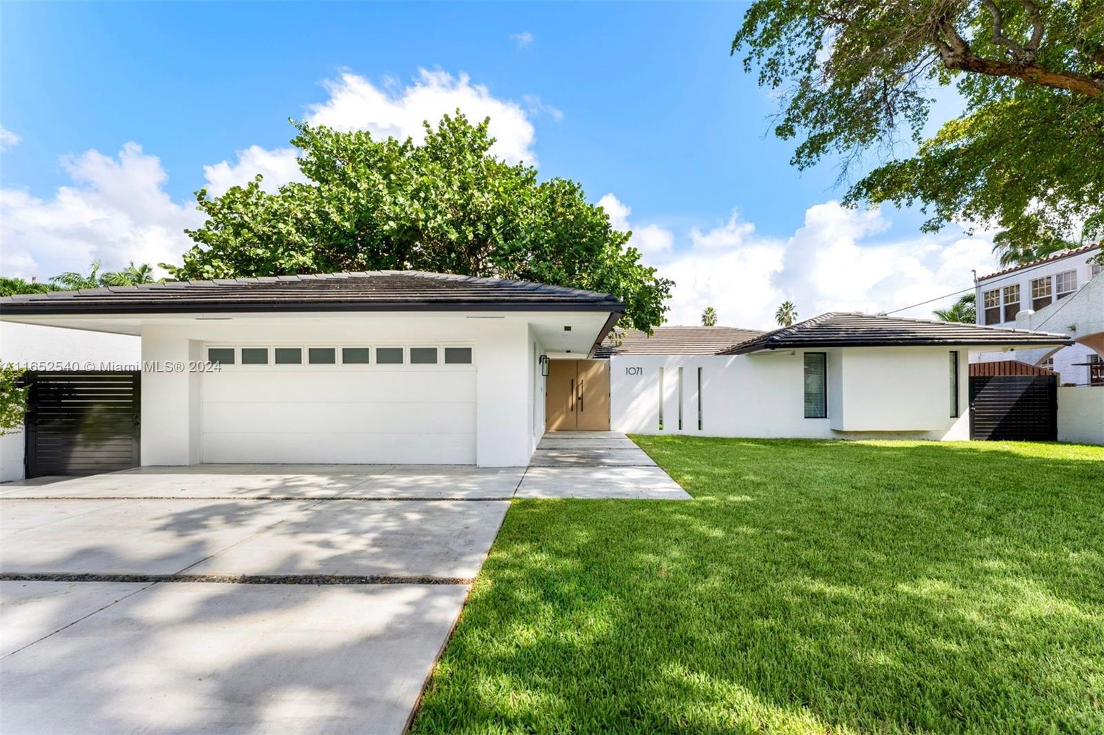 a view of a house with a yard and a garage