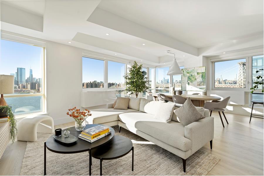 a living room with furniture and a dining table with kitchen view