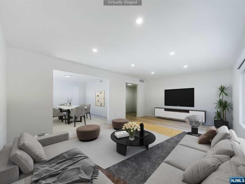 a living room with furniture wooden floor and a flat screen tv