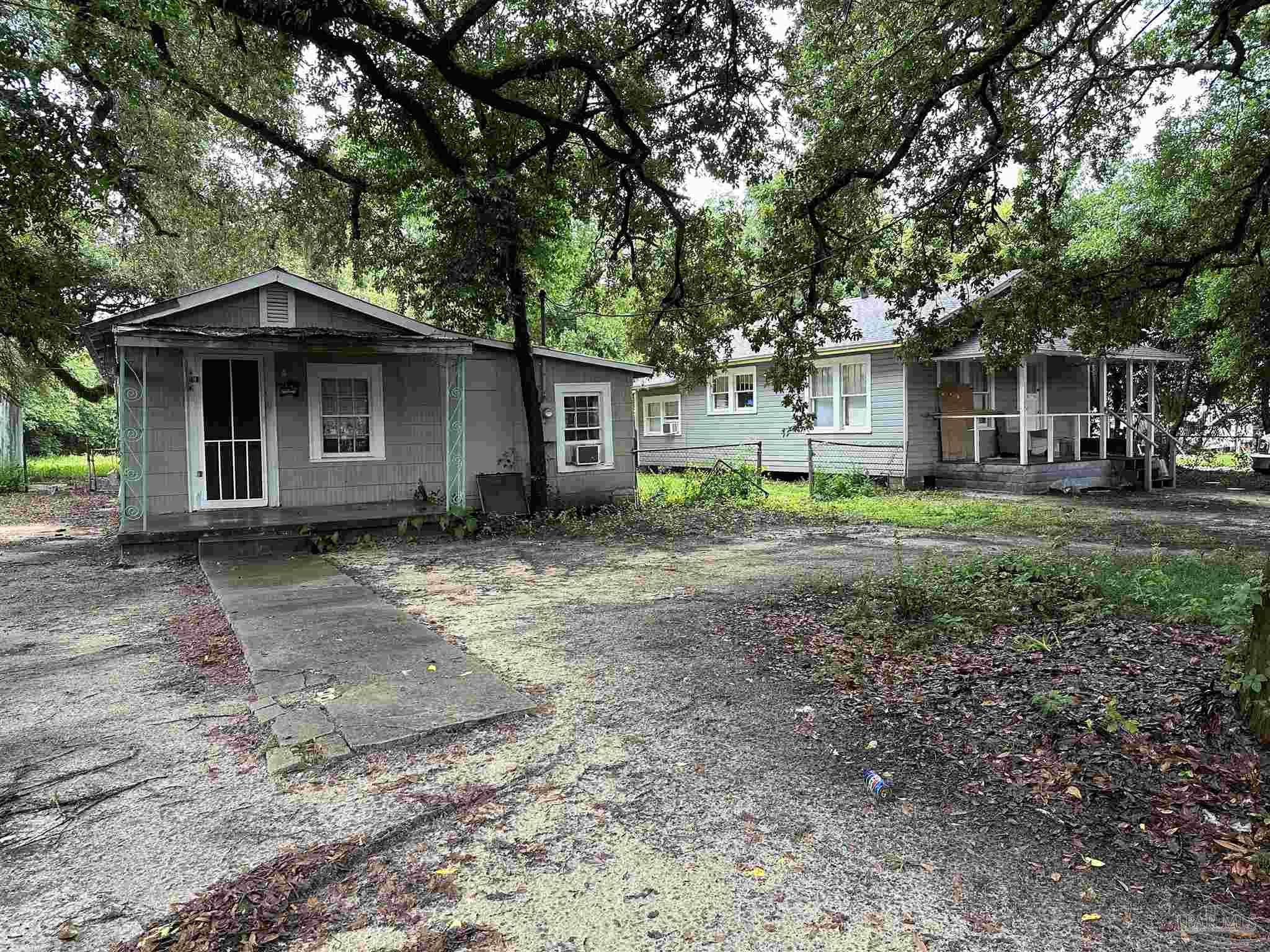 a view of a house with yard and a tree