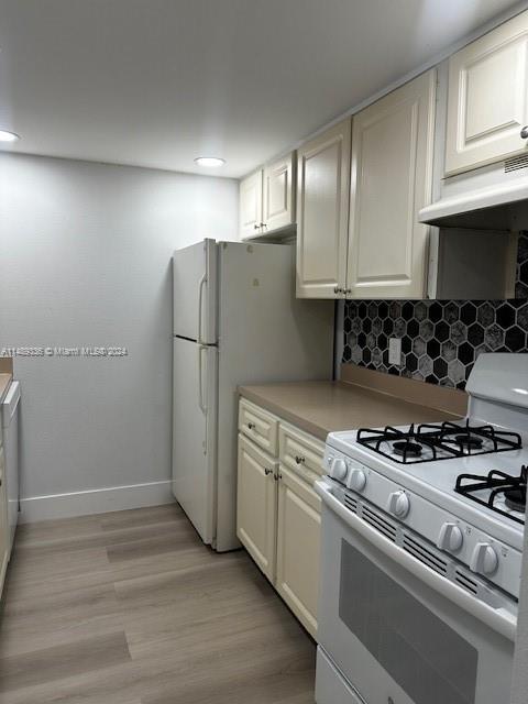 a kitchen with a stove and a refrigerator