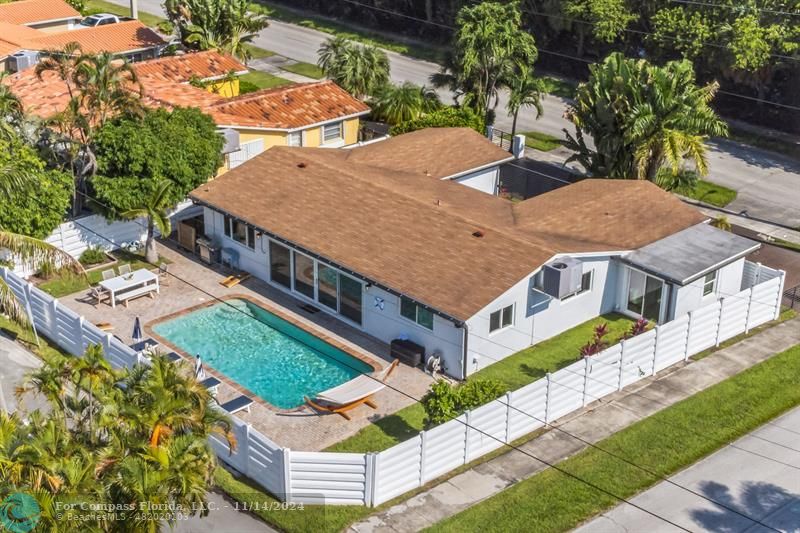 an aerial view of a house with yard patio and outdoor seating