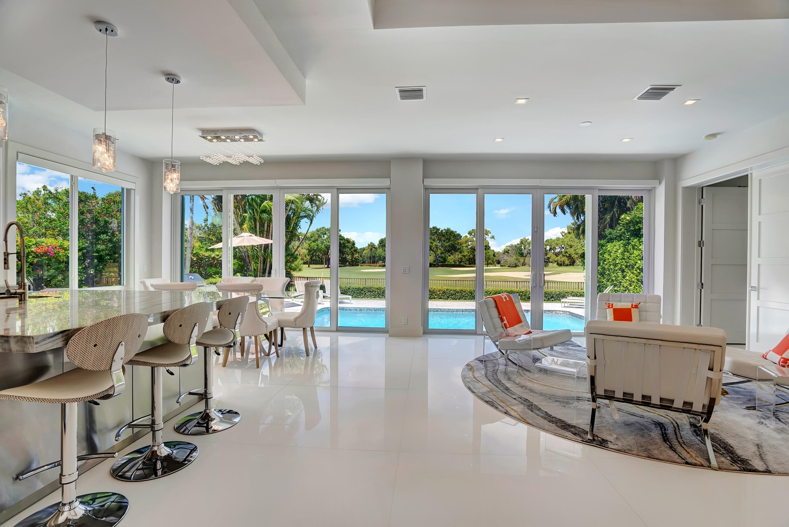 a living room with furniture and large windows