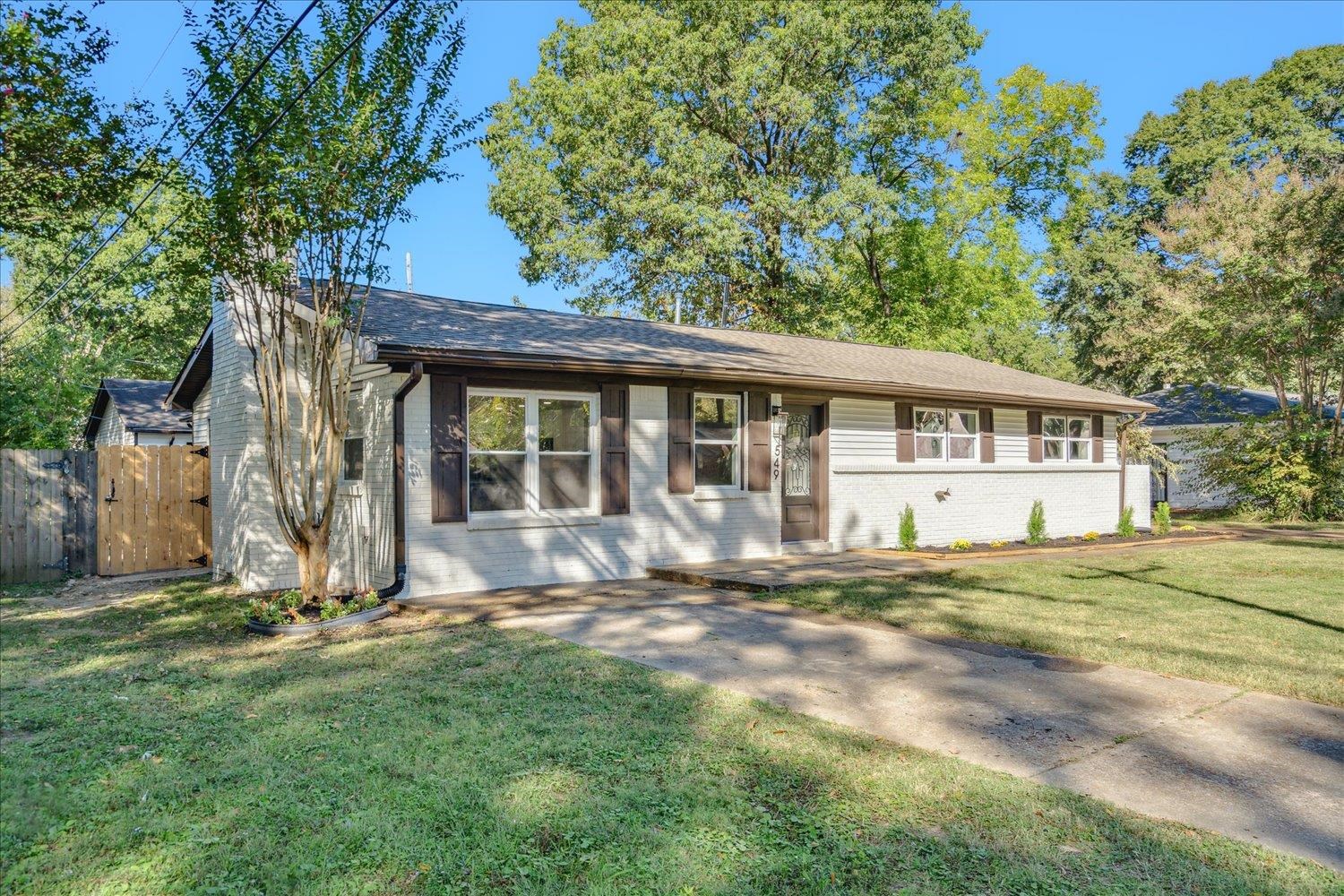 Single story home with a front lawn