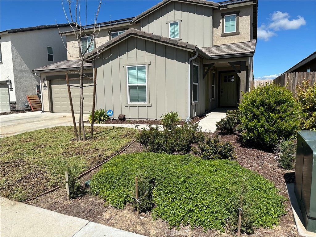 a front view of a house with garden