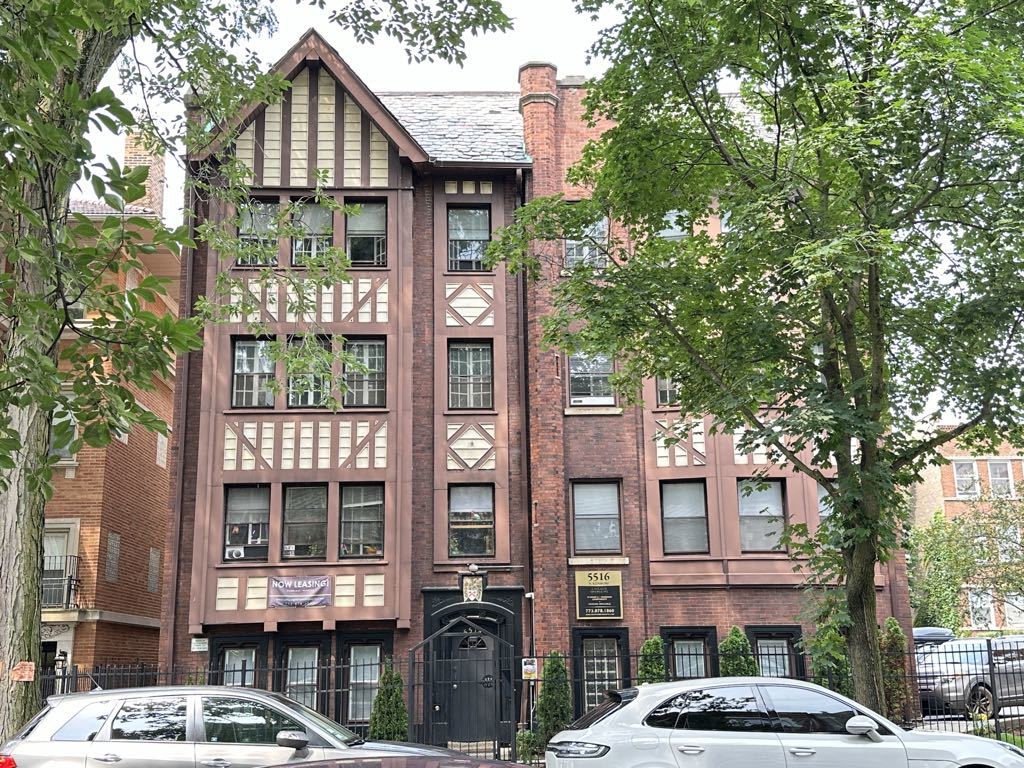 a front view of a residential apartment building with a yard