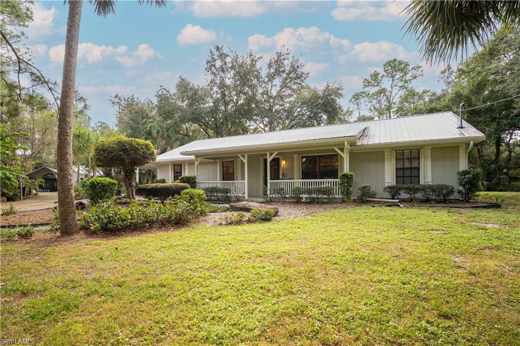 Ranch-style house with a front lawn and covered porch