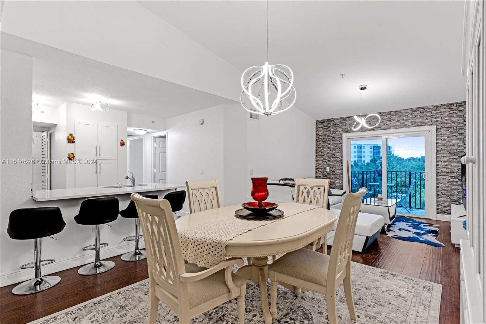 a view of a dining room with furniture wooden floor and chandelier