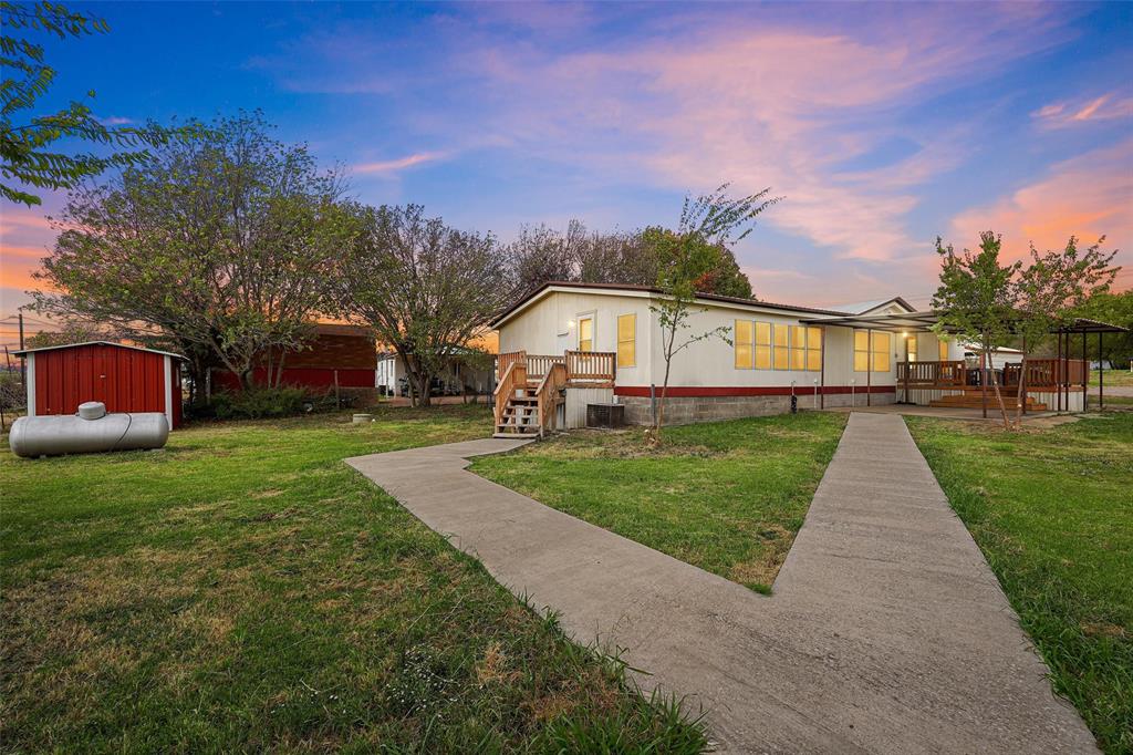 a view of house with outdoor space and garden