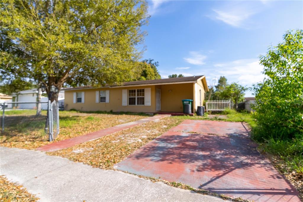 a front view of a house with a yard and trees