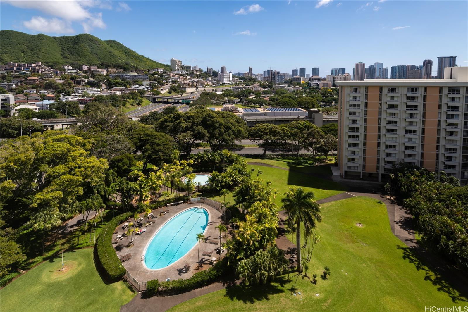 a view of a swimming pool with a yard and mountain view