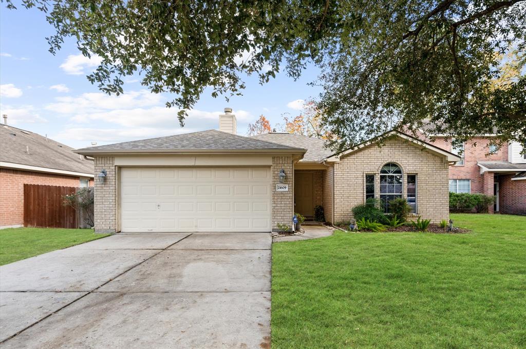 Charming shaded driveway with a gentle slope.