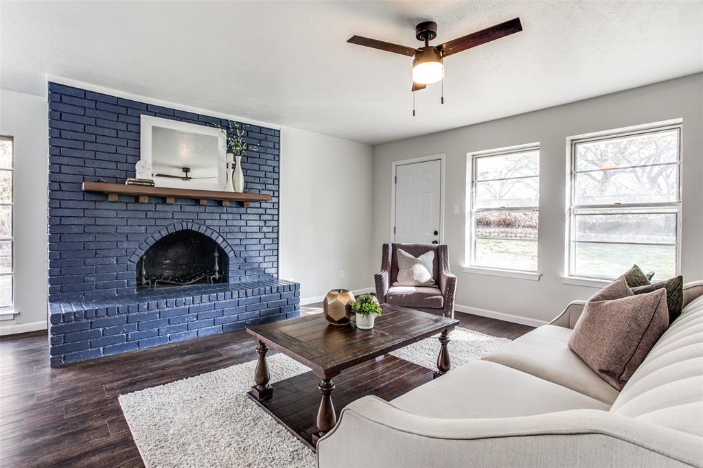 a living room with furniture a window and a fireplace