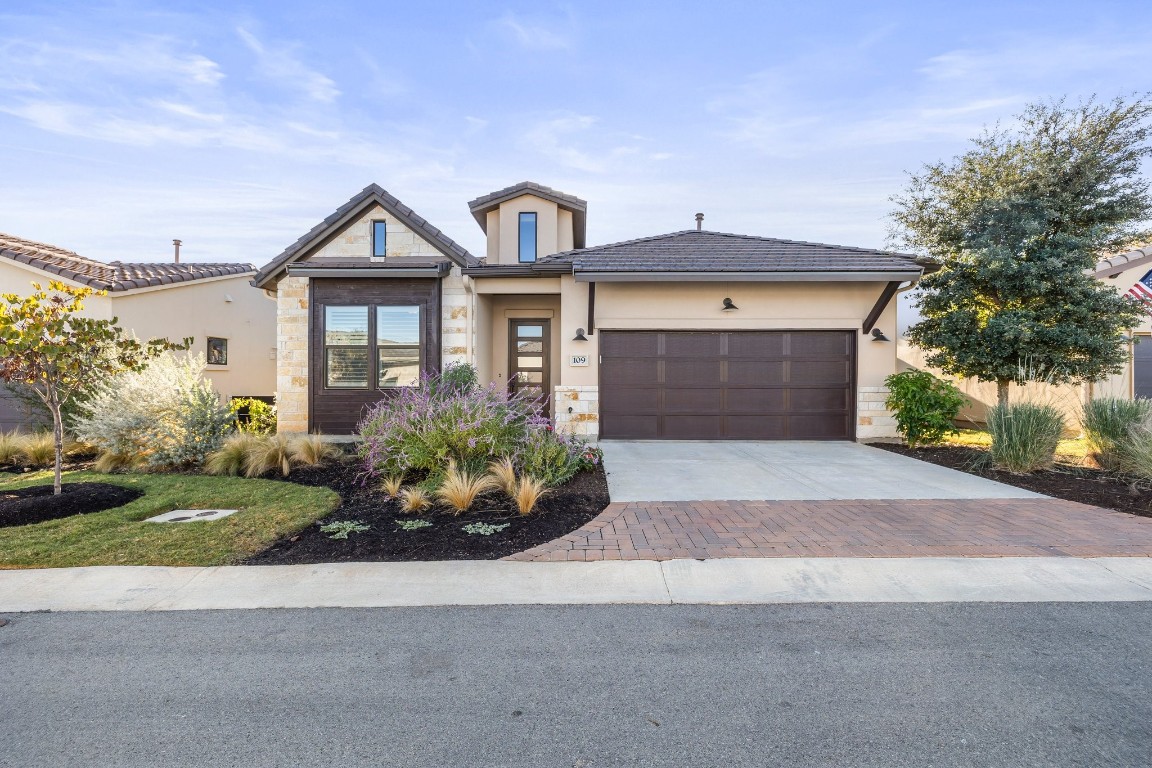 a front view of a house with garden