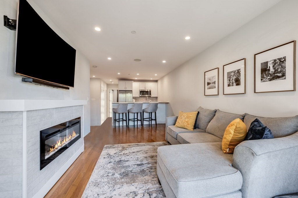 a living room with furniture fireplace and flat screen tv