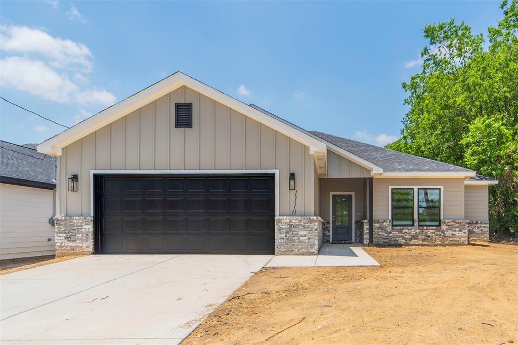 a front view of a house with yard and garage