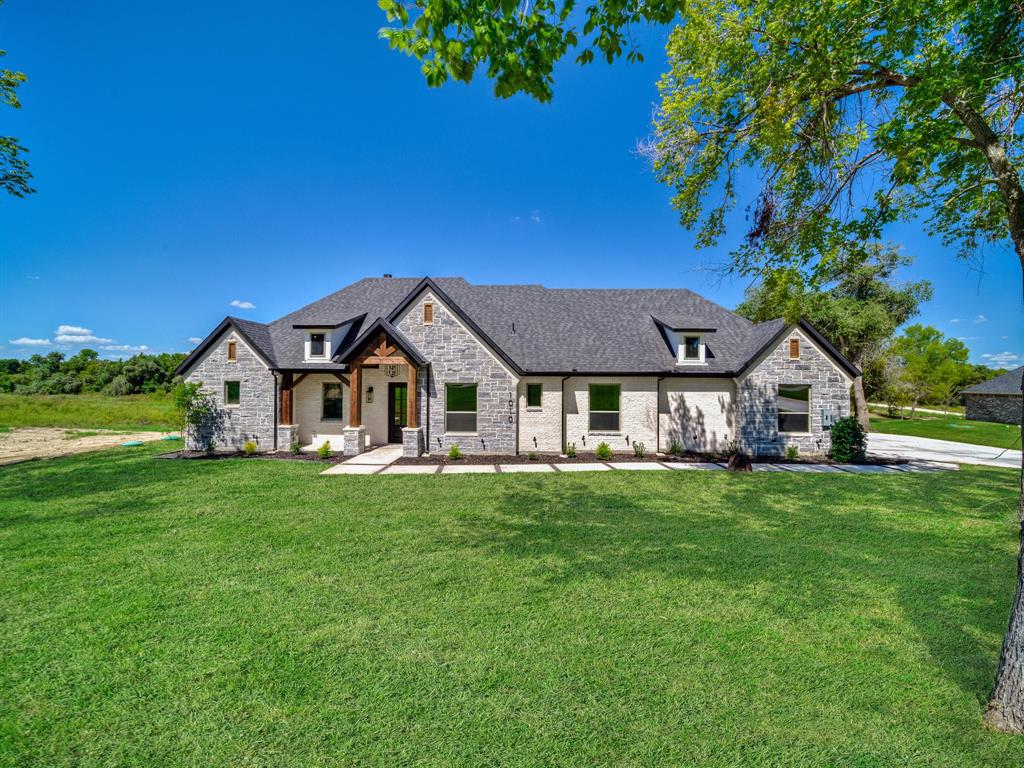 a house with a big yard and large trees