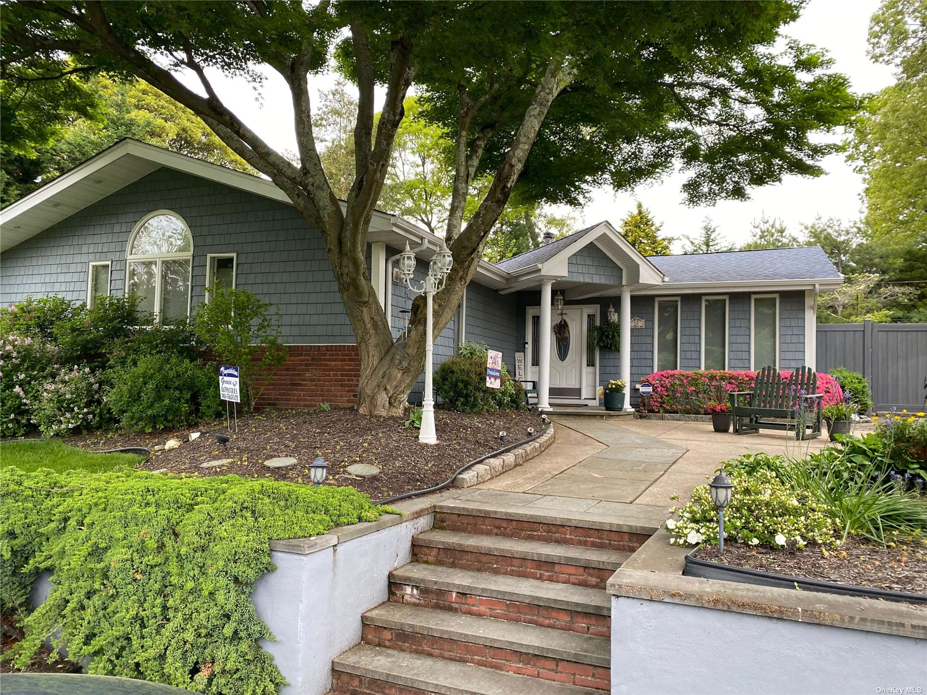 a front view of a house with garden