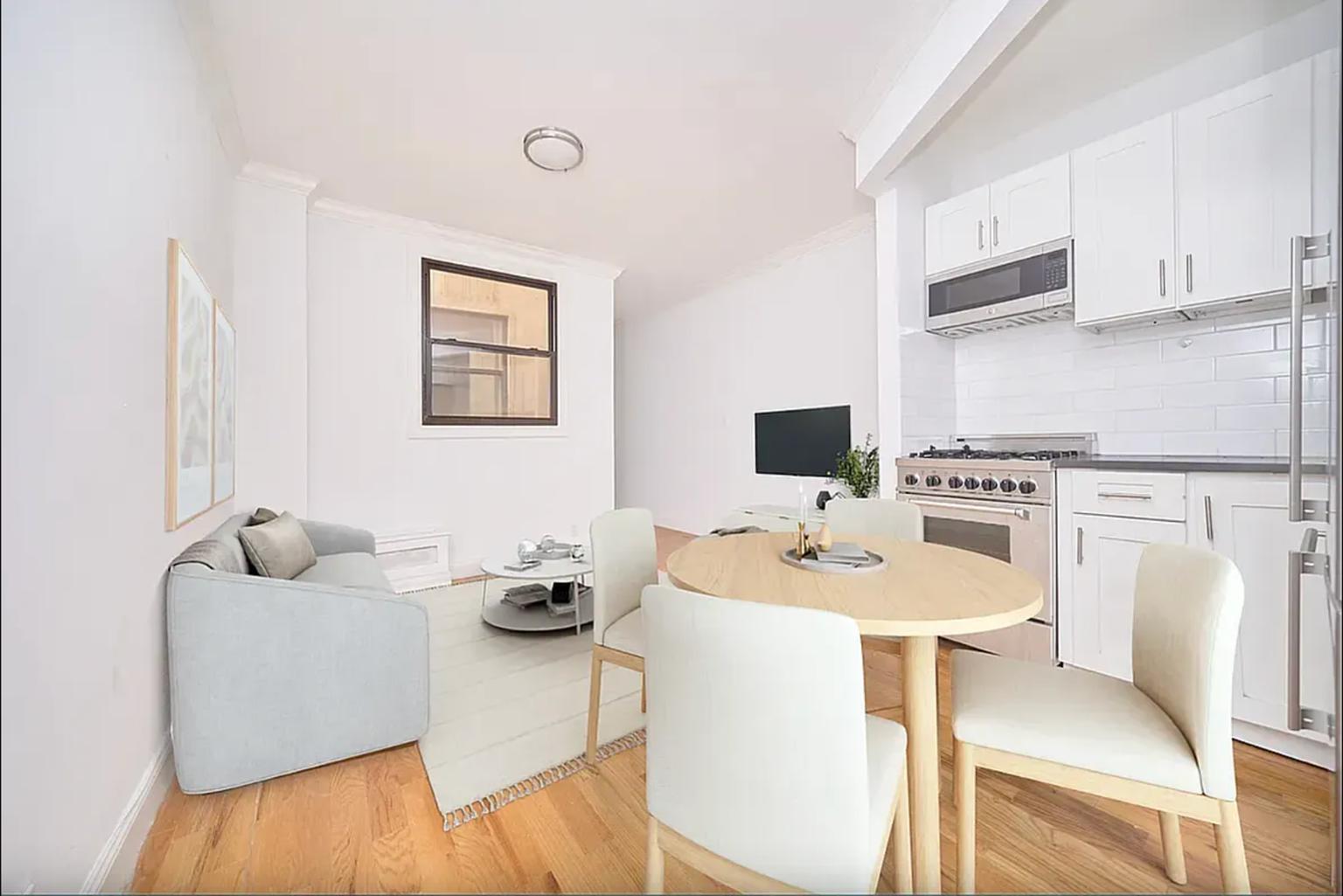 a dining room with furniture and a wooden floor