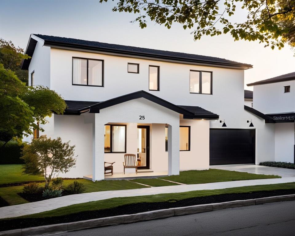 a front view of a house with a yard outdoor seating and garage