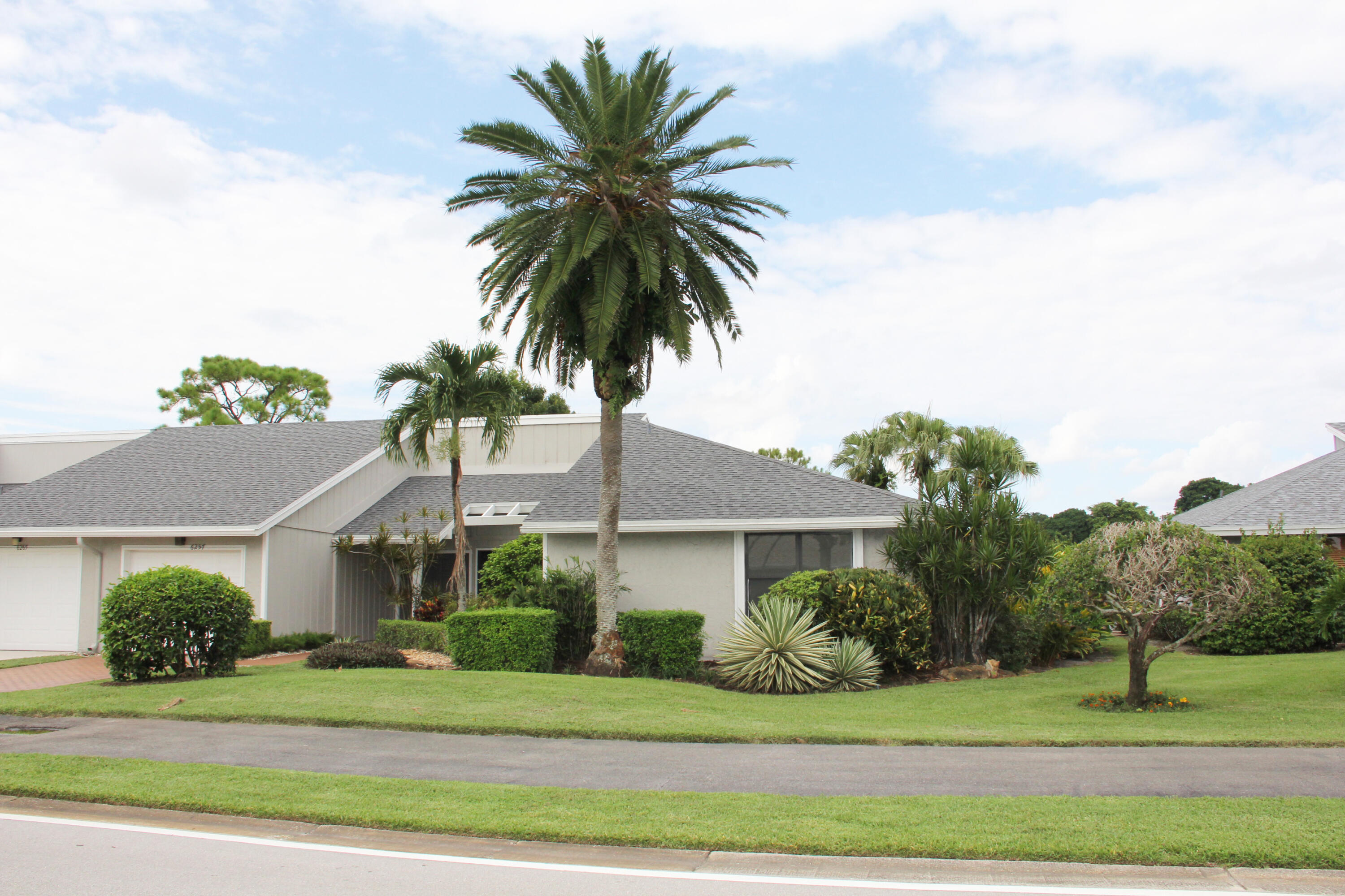 a front view of a house with a garden