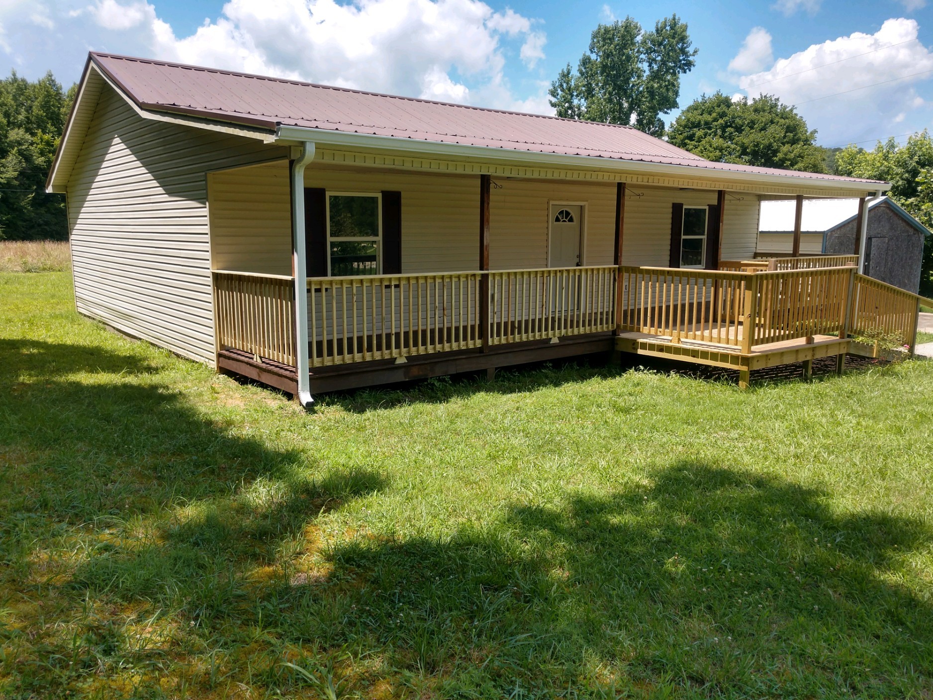 a view of a house with a yard and deck