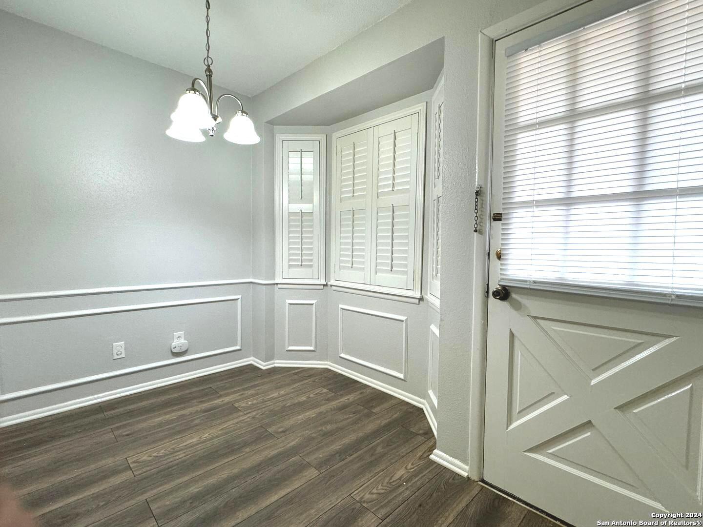 a view of a room with wooden floor and windows