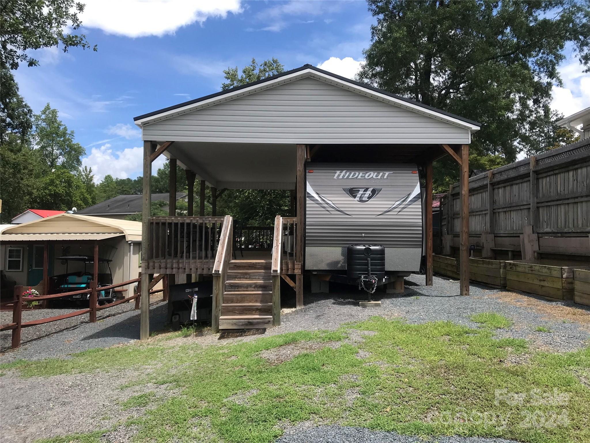 a front view of a house with yard and furniture