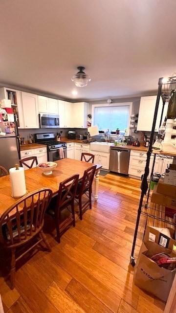 a view of a dining room with furniture wooden floor and a rug