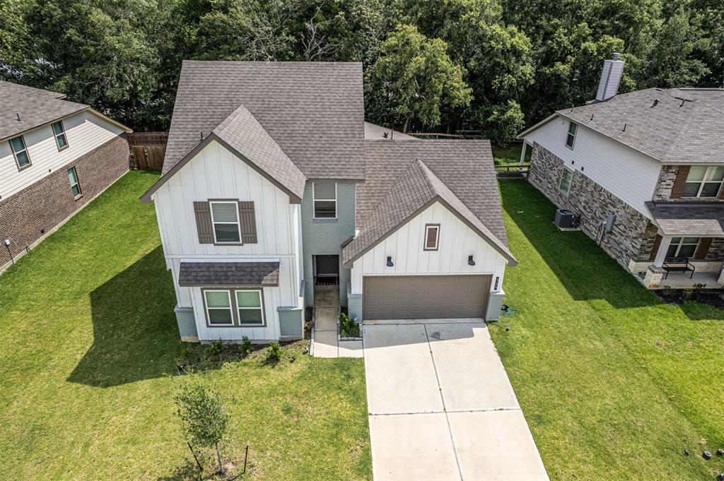 a aerial view of a house with a yard and potted plants