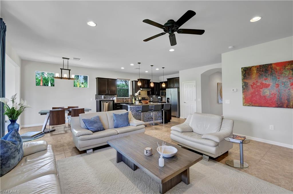 a living room with furniture and kitchen view