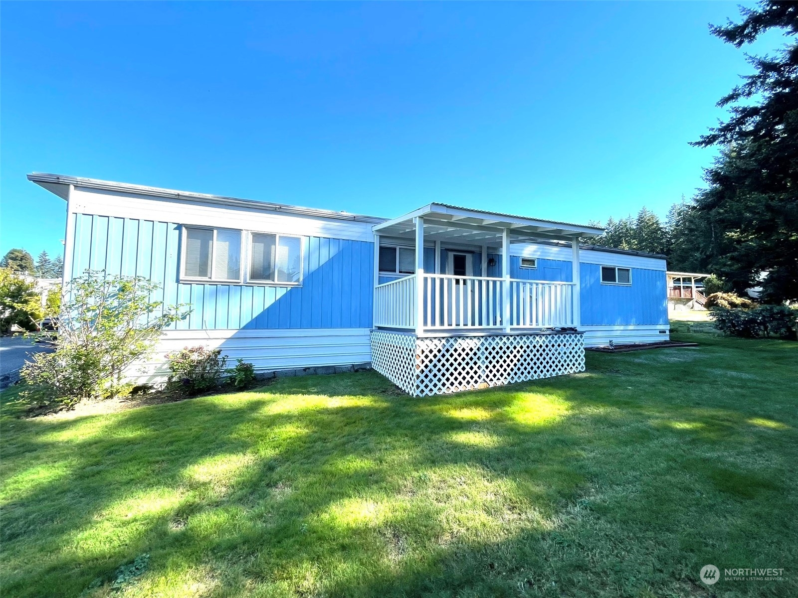 a view of a house with a swimming pool and sitting area