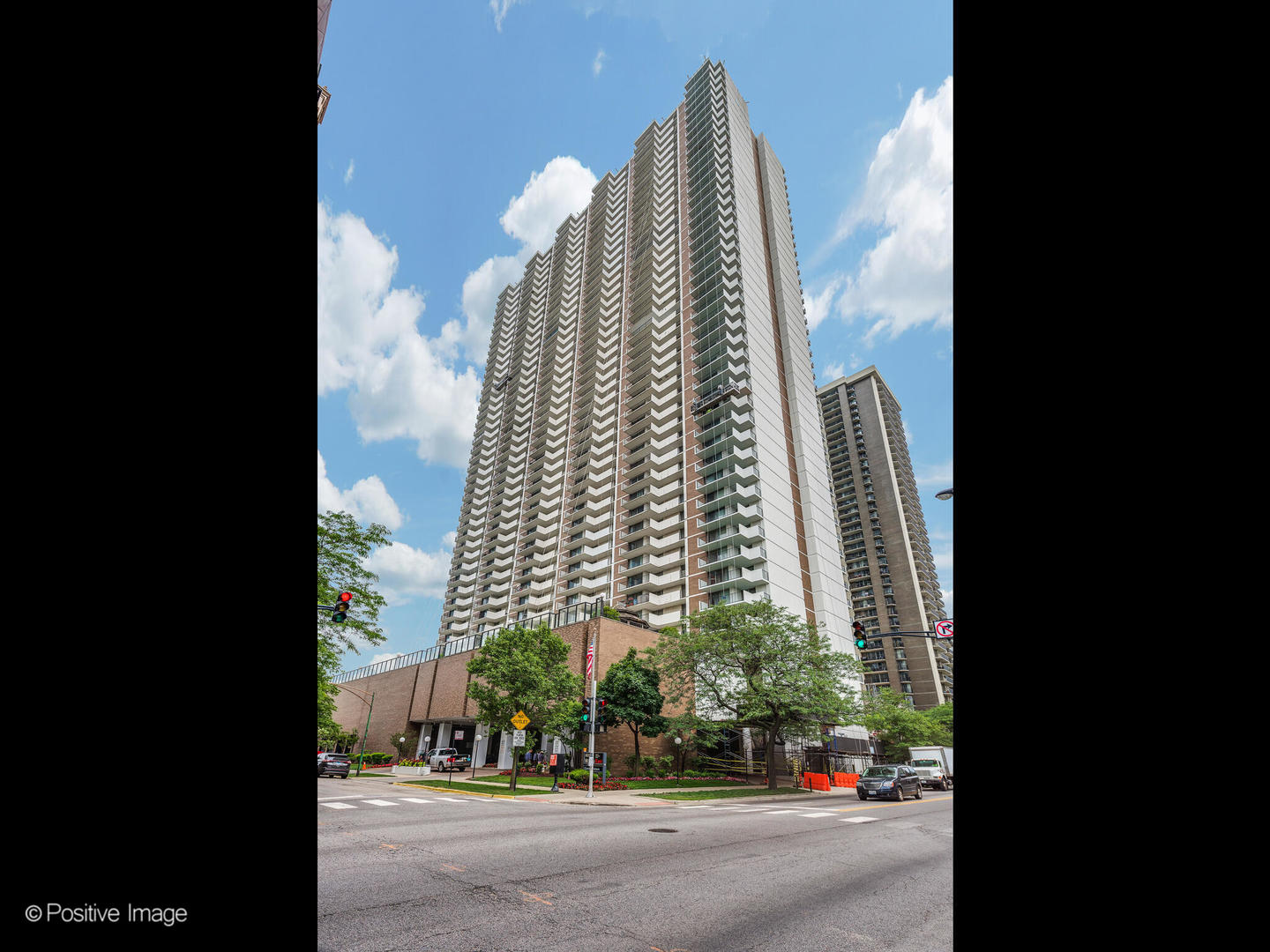 a view of a tall building next to a road