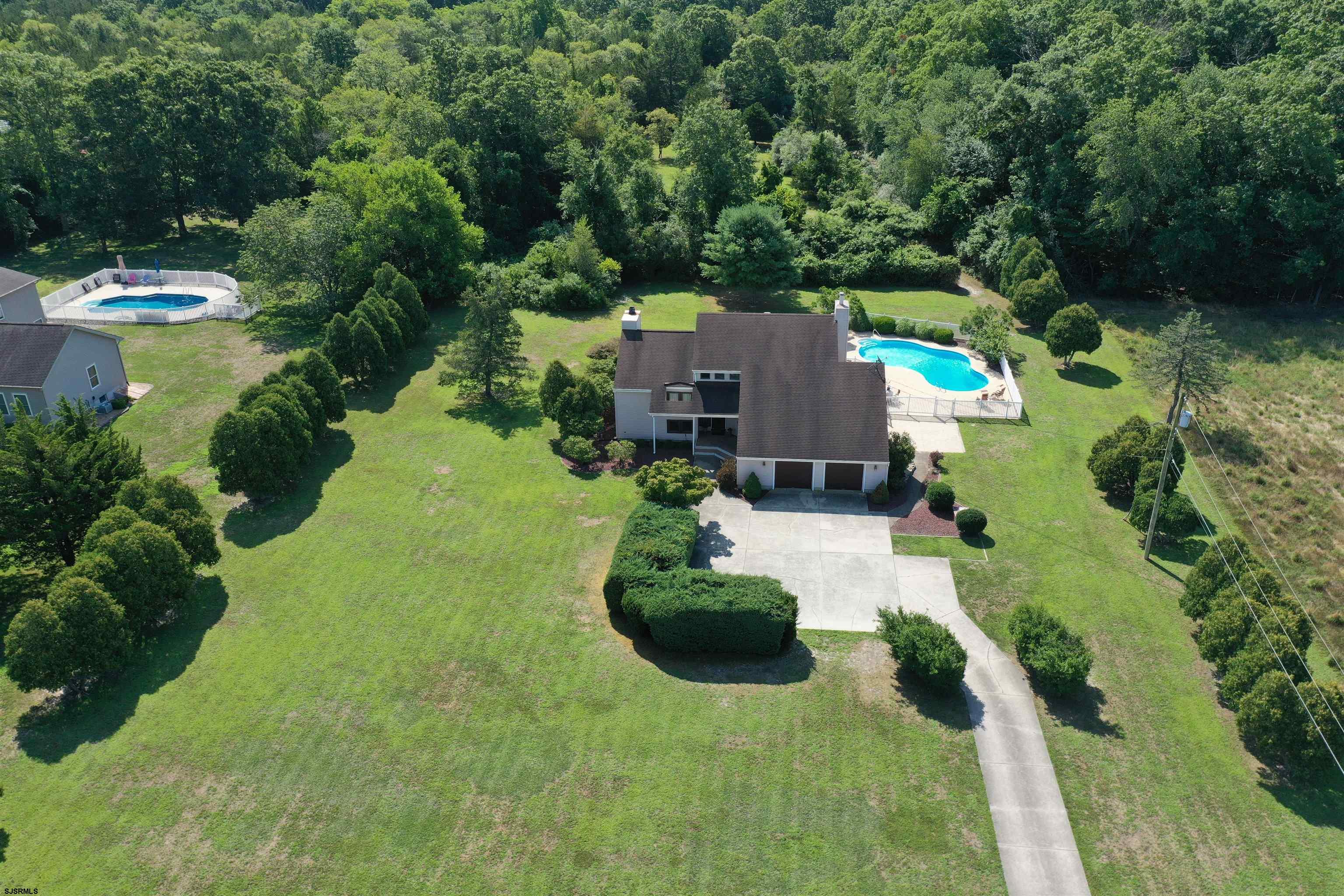 an aerial view of a house with yard swimming pool and outdoor seating