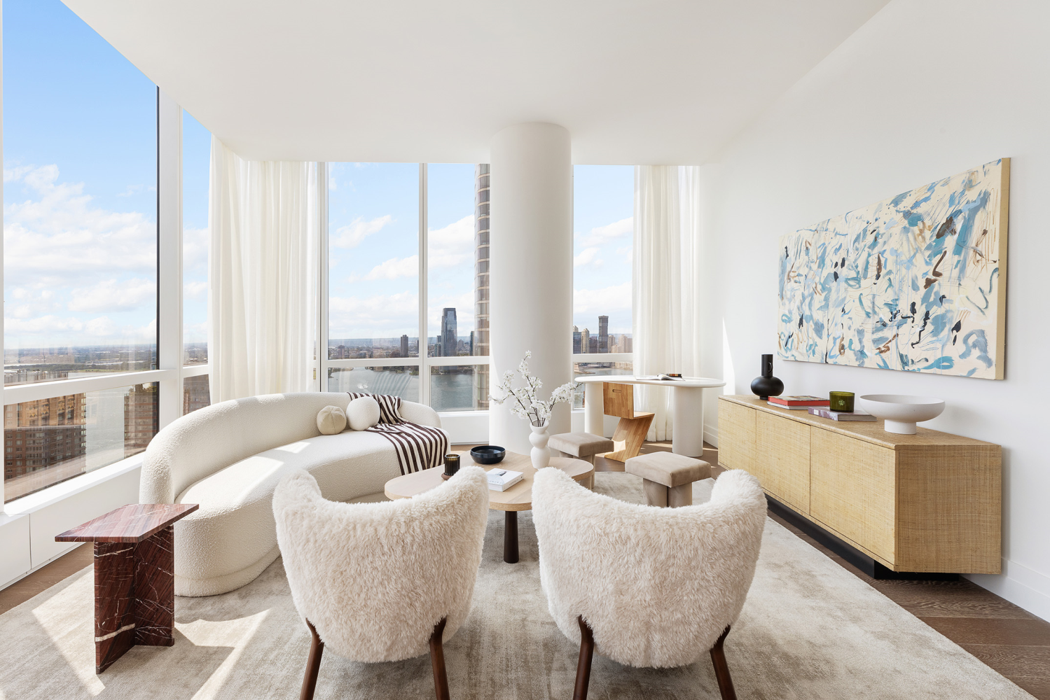 a living room with furniture and floor to ceiling windows