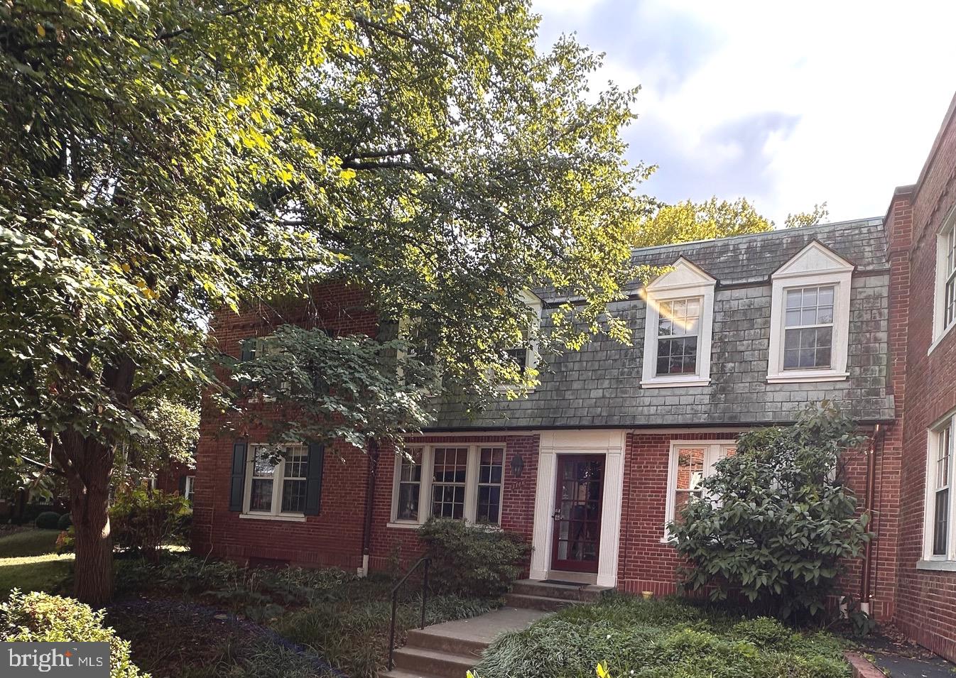 front view of a house with a tree