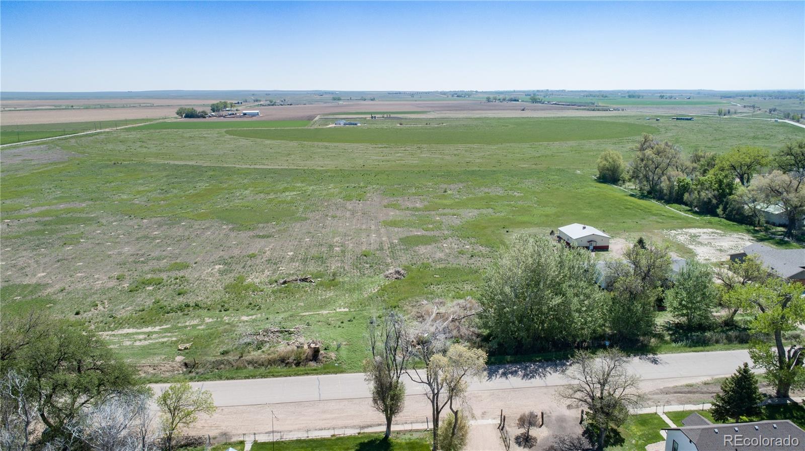 a view of a field with an ocean view