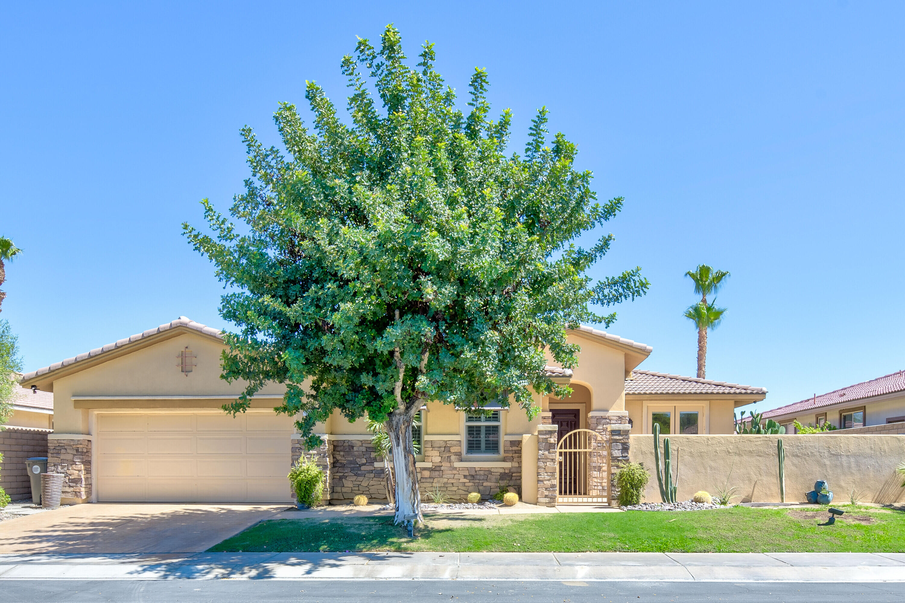 a front view of a house with a yard and a garage