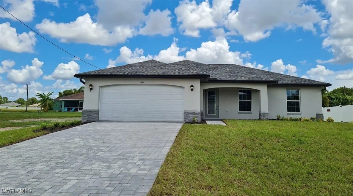 a front view of a house with a garden and yard