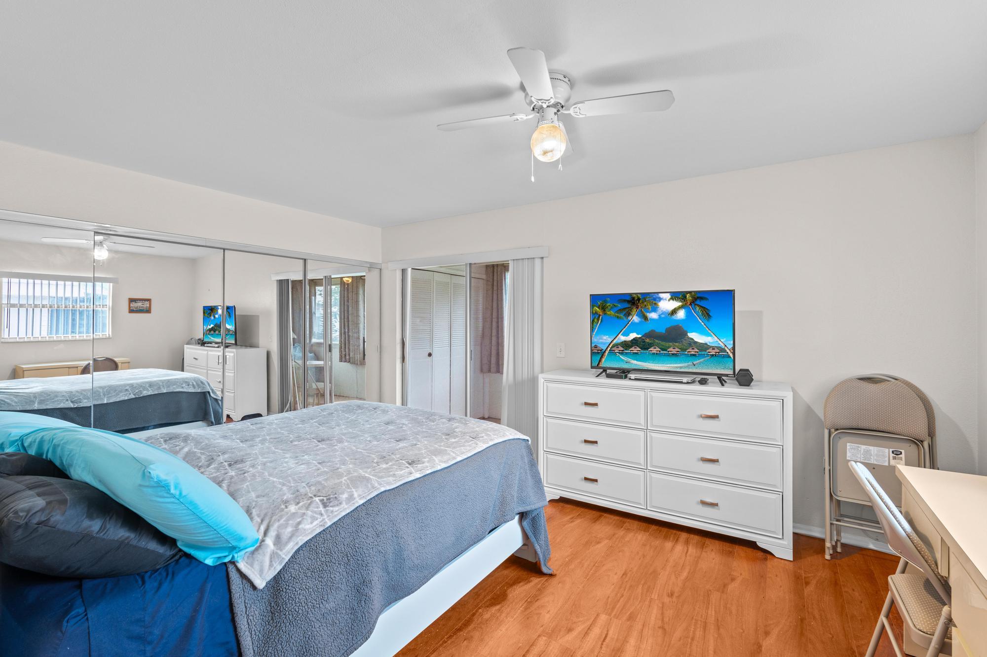 a bedroom with a bed and a flat screen tv