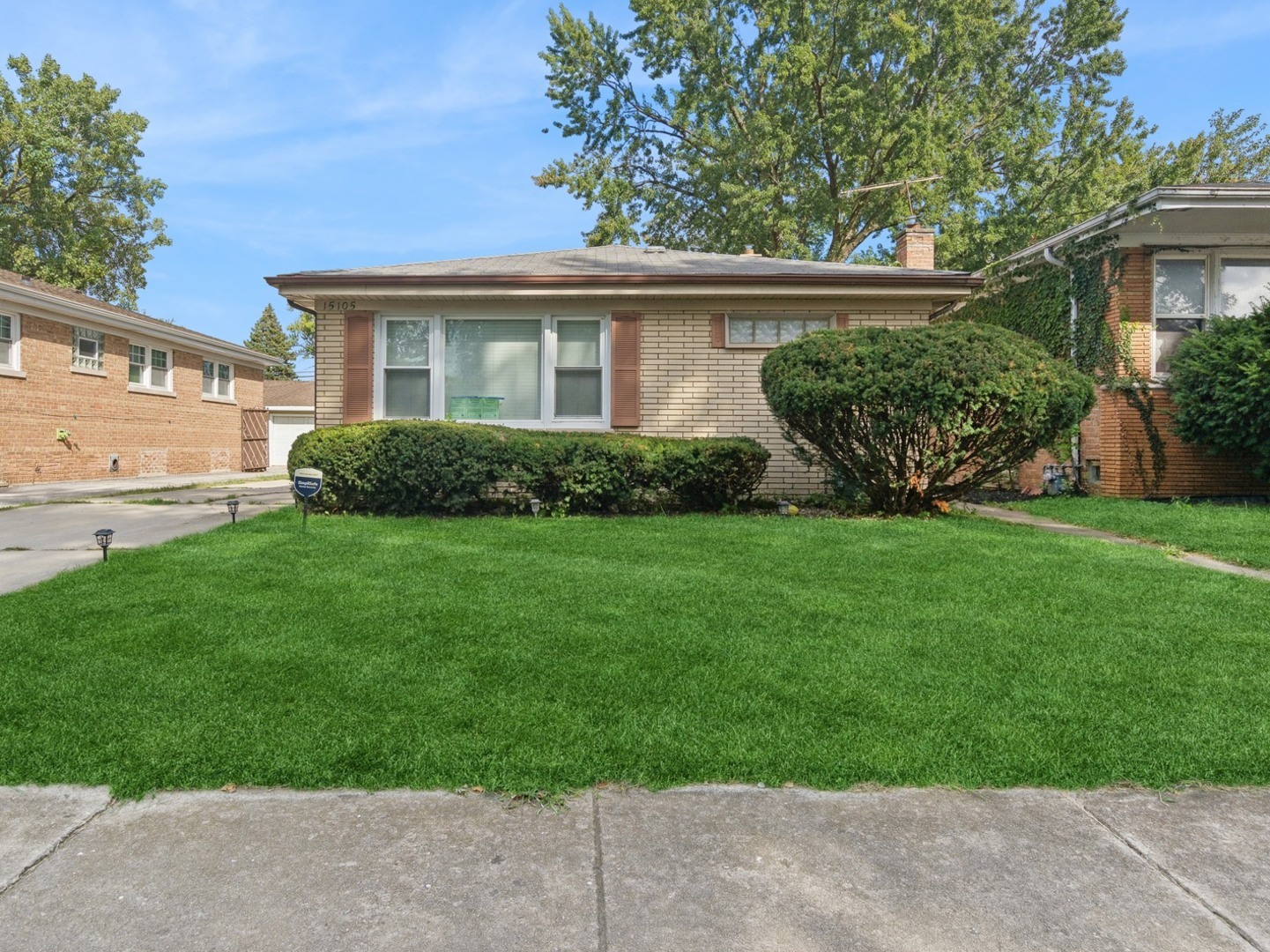 a view of a house with a yard and plants