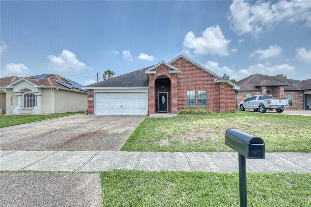 a front view of a house with a yard and entertaining space