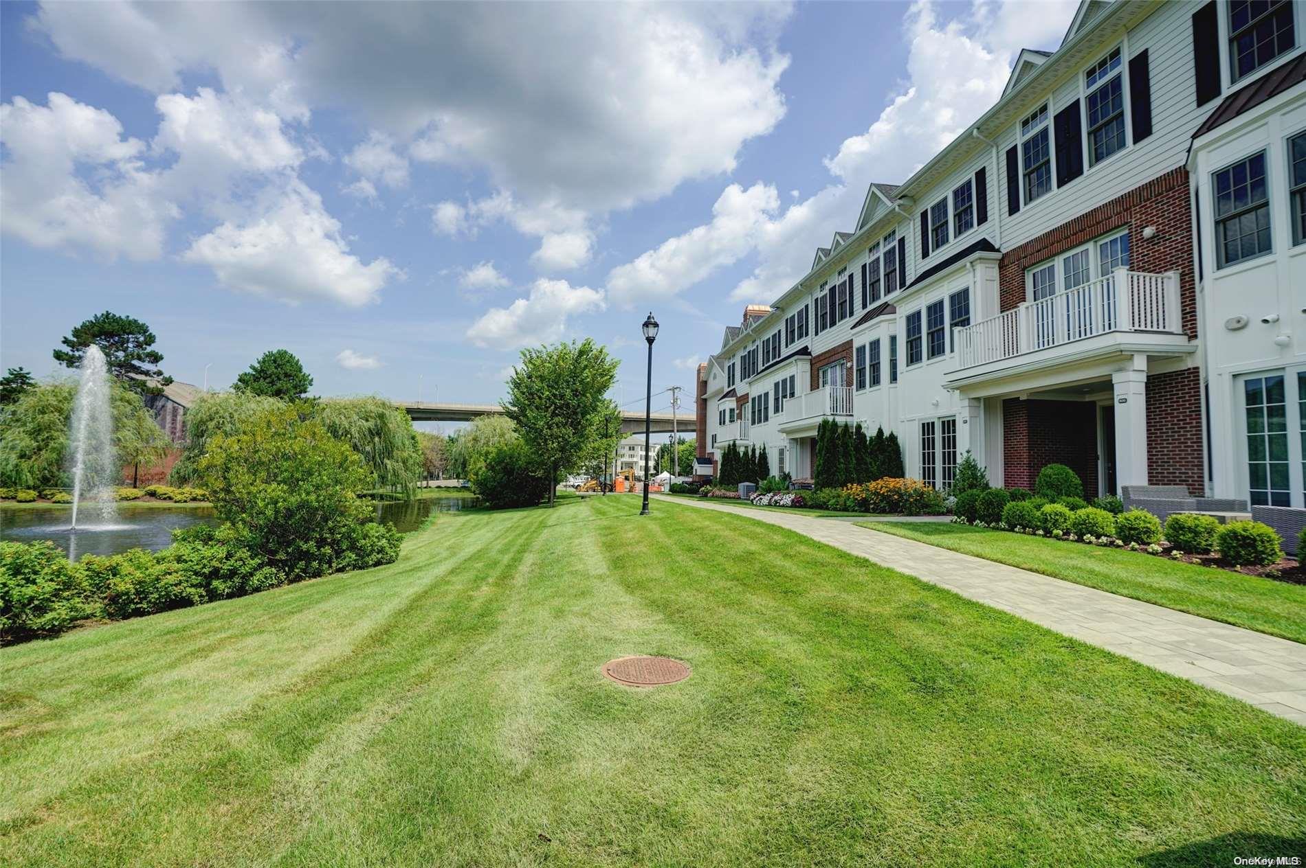 a front view of a residential apartment building with a yard