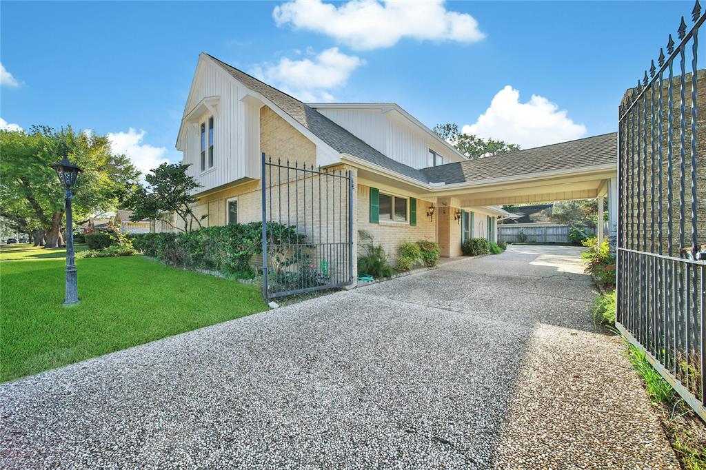 a view of a house with a yard and garden