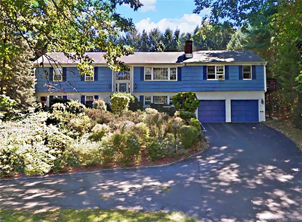 a view of a brick house with a yard