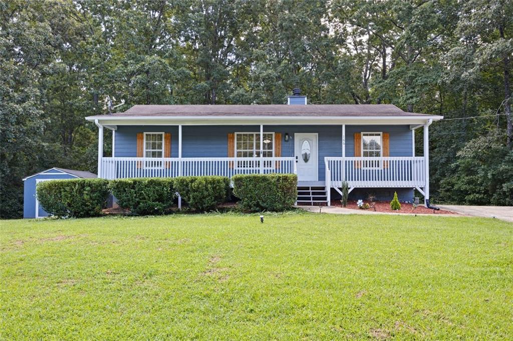 a view of a house with yard and sitting area